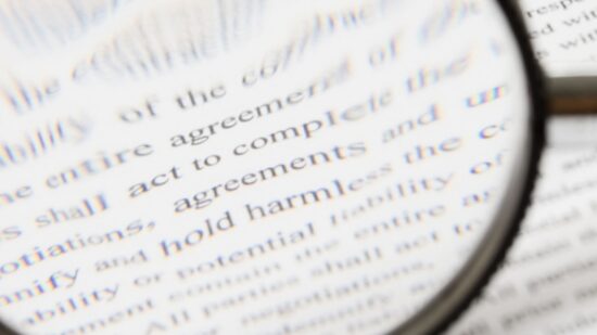 contract fine print magnifying glass Shutterstock_34559689